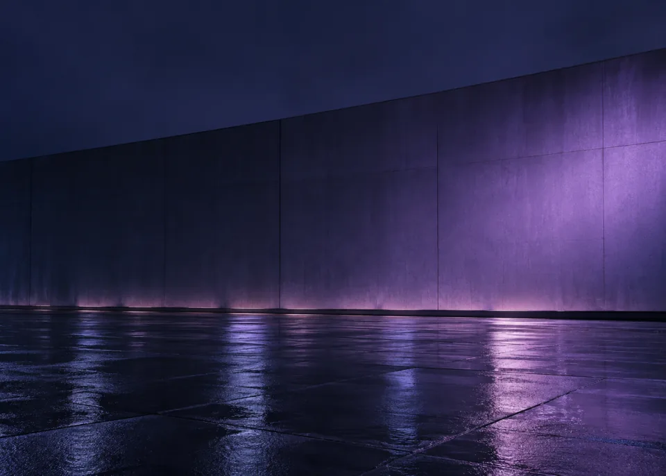 Violet Rain: An empty smooth urban wall and rain-wet pavement reflecting a broad subdued violet light gradient, clean horizon below center, abstract spacious framing.